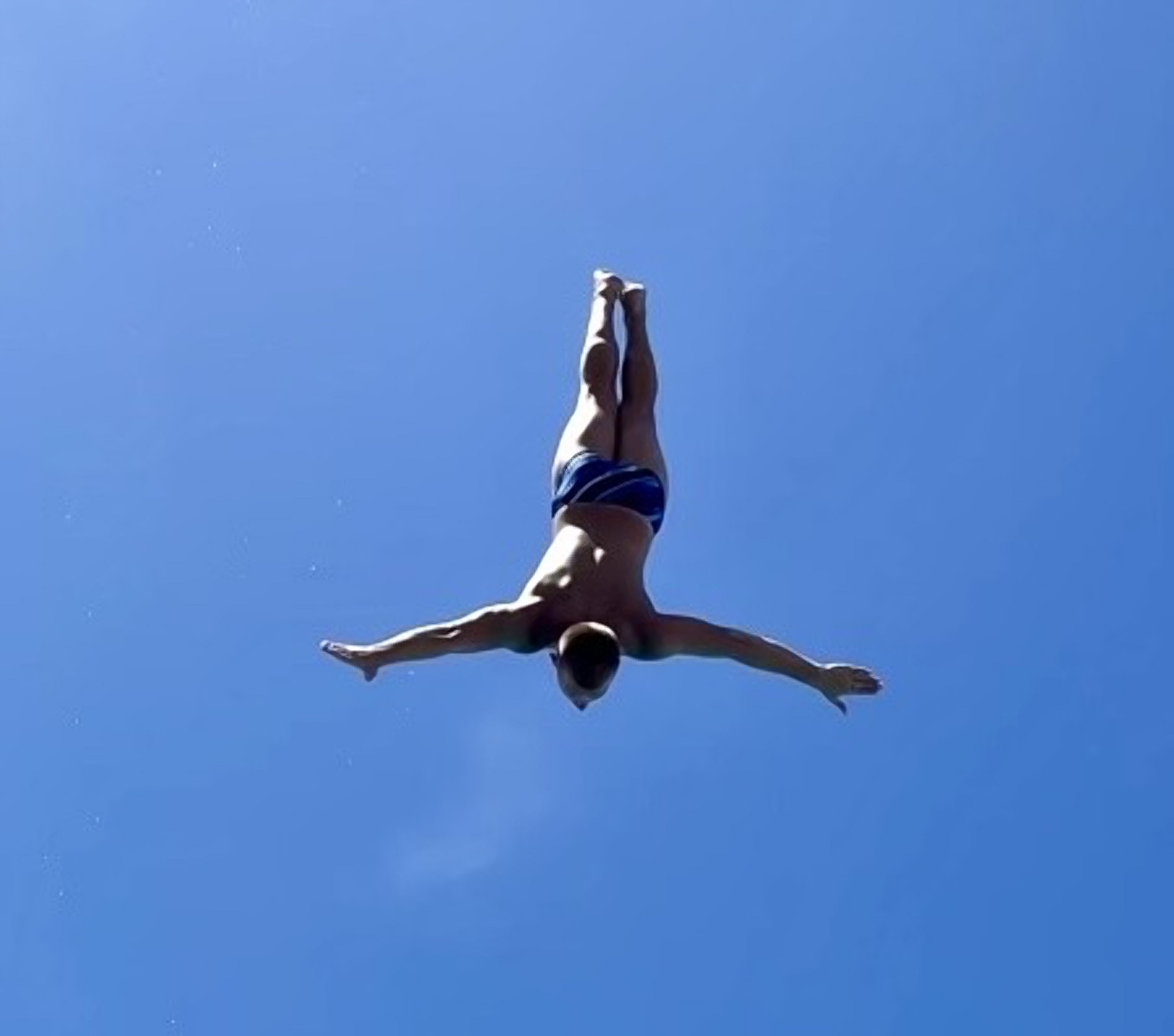 A diver diving off of 3 meter springboard